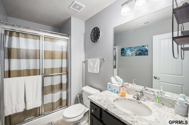 16604 Weber St, Bennington, NE 68007 - bathroom with toilet, vanity, a shower stall, a textured ceiling, and visible vents