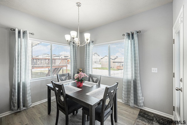 16604 Weber St, Bennington, NE 68007 - dining area featuring baseboards, a chandelier, and light wood-type flooring