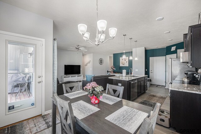 16604 Weber St, Bennington, NE 68007 - dining space with light wood-type flooring and ceiling fan with notable chandelier