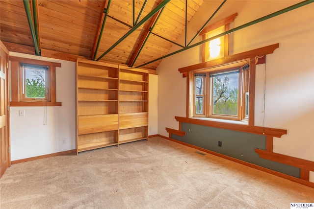 carpeted spare room featuring wood ceiling, plenty of natural light, lofted ceiling with beams, and visible vents