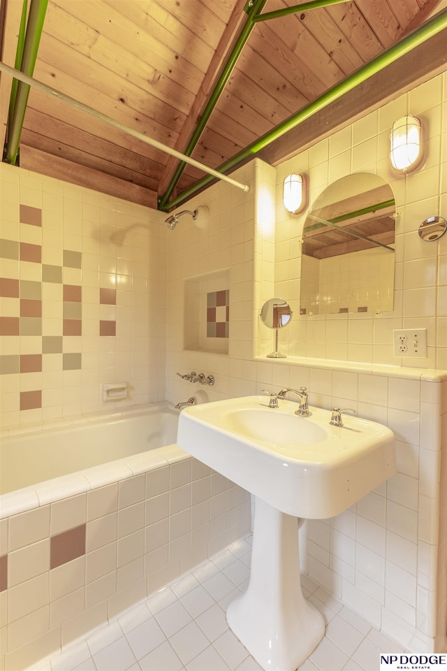 full bath featuring tile patterned floors, tiled shower / bath combo, wooden ceiling, and tile walls