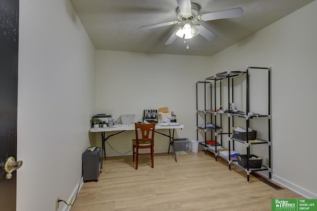office space featuring baseboards, wood finished floors, and a ceiling fan