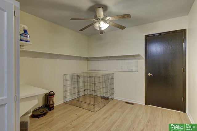 laundry area with baseboards, visible vents, wood finished floors, and a ceiling fan