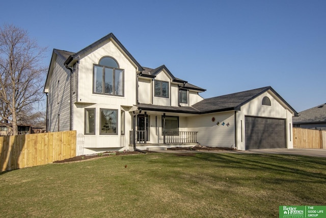 view of front of house with a front yard, covered porch, concrete driveway, fence, and a garage