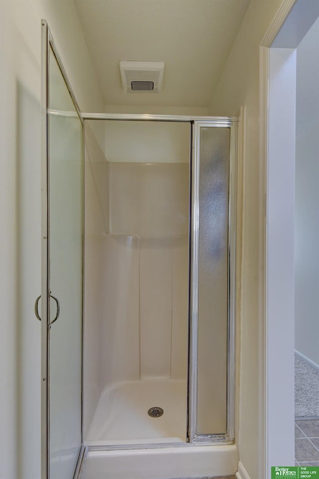 bathroom featuring a shower stall and visible vents