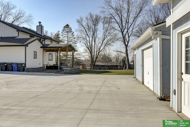 exterior space with a garage and concrete driveway