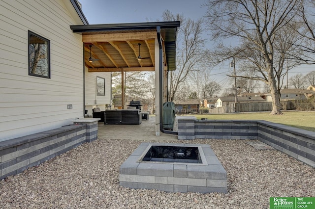 exterior space with an outdoor living space with a fire pit, fence, and ceiling fan