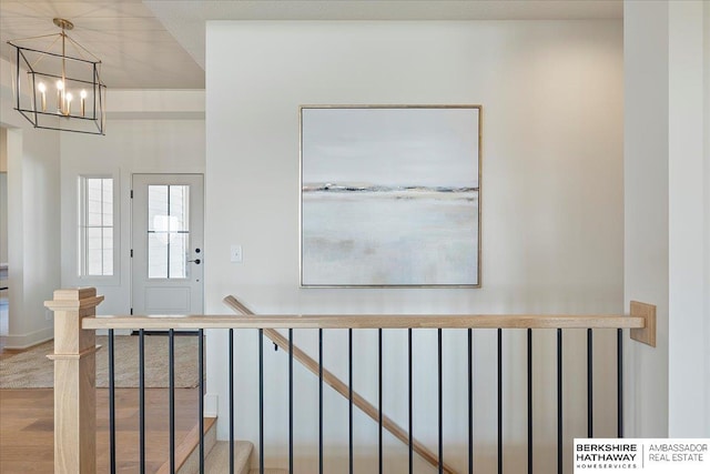 foyer featuring a notable chandelier and wood finished floors