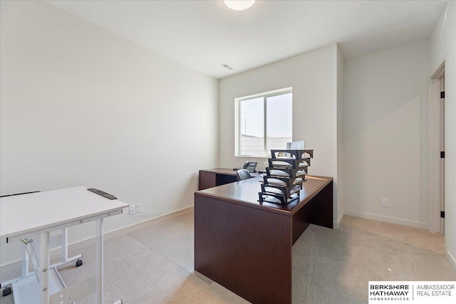 office featuring light colored carpet, baseboards, and visible vents