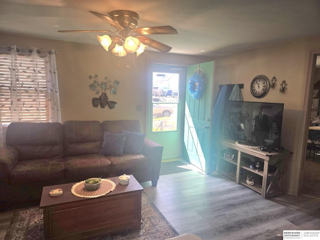 living room with wood finished floors and ceiling fan