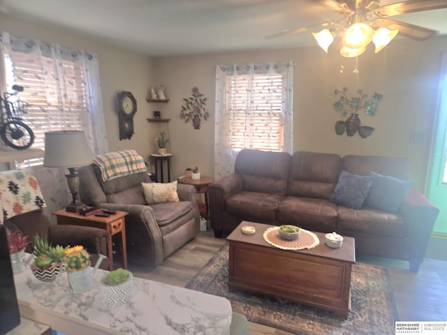 living room with wood finished floors and a ceiling fan