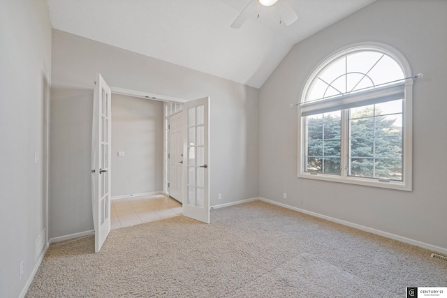 unfurnished bedroom featuring french doors, light carpet, lofted ceiling, baseboards, and ceiling fan