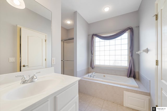 bathroom with tile patterned floors, an enclosed shower, vanity, and a garden tub