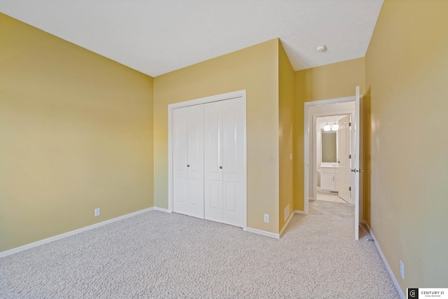 unfurnished bedroom featuring baseboards, a closet, and light carpet