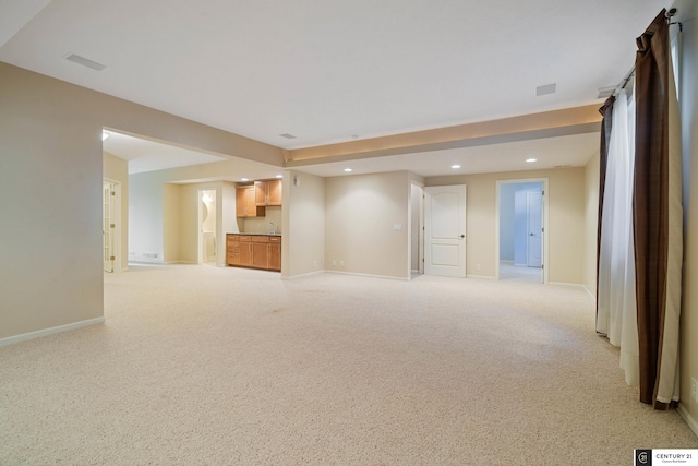 unfurnished living room featuring baseboards, visible vents, recessed lighting, and light carpet