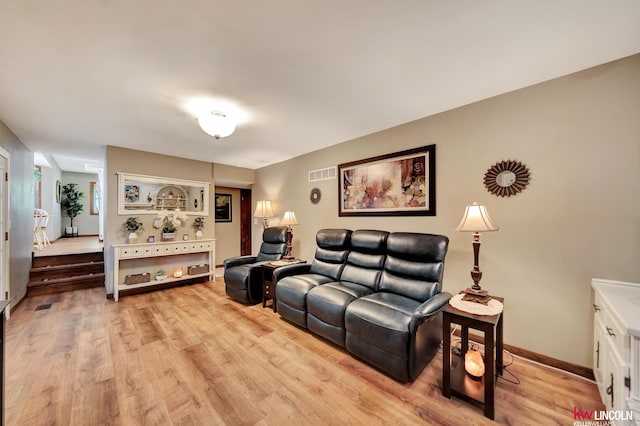 living area with light wood-style floors and baseboards