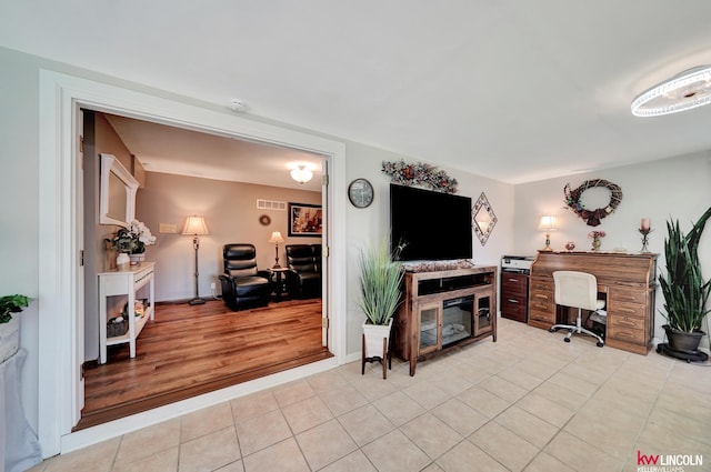 living room featuring light tile patterned floors and an office area