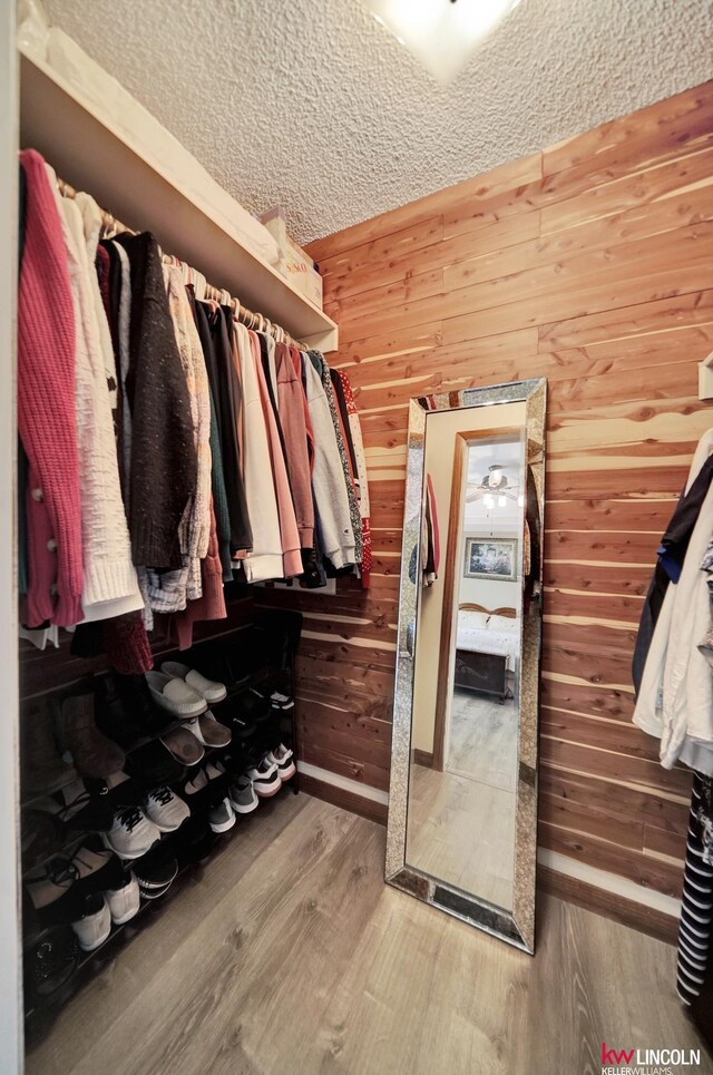 walk in closet featuring wood finished floors