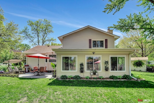 view of front facade featuring a patio area, a front lawn, and a chimney