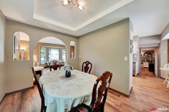 dining space featuring light wood finished floors and baseboards