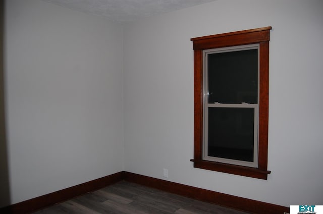 405 E 5th St, Mccook, NE 69001 - spare room with baseboards and dark wood-style floors