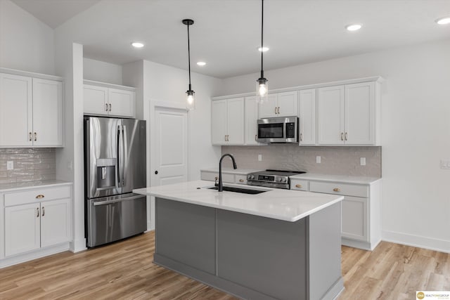 kitchen featuring light countertops, light wood-style floors, white cabinets, and stainless steel appliances