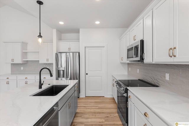 kitchen featuring white cabinets, a sink, stainless steel appliances, and open shelves