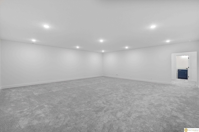 finished below grade area with baseboards, carpet floors, and recessed lighting