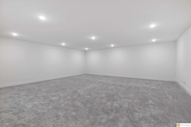 empty room with baseboards, carpet floors, and recessed lighting