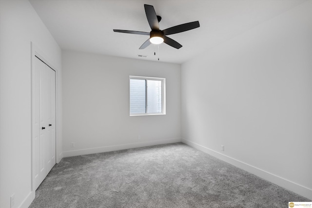 unfurnished bedroom with baseboards, visible vents, carpet floors, and a ceiling fan