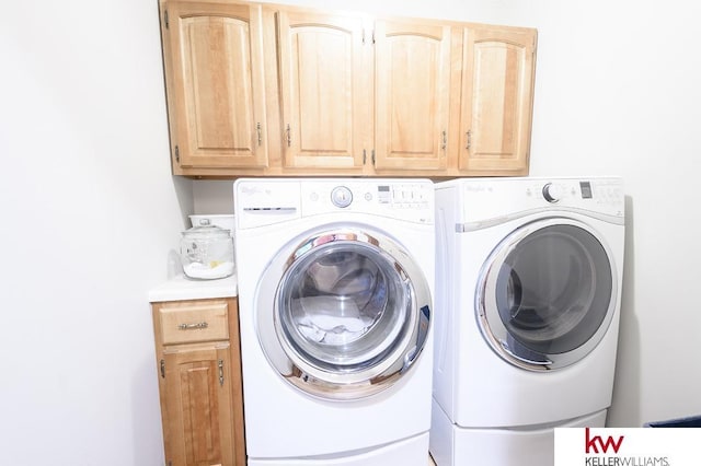 laundry room with washing machine and dryer and cabinet space