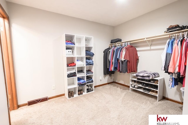 walk in closet featuring visible vents and carpet floors