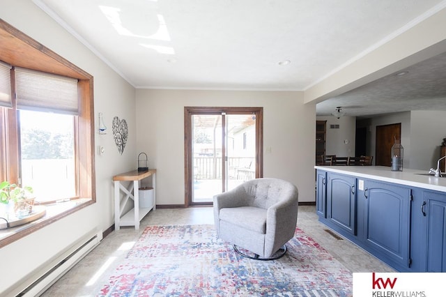 living area featuring baseboards, visible vents, a baseboard heating unit, and ornamental molding