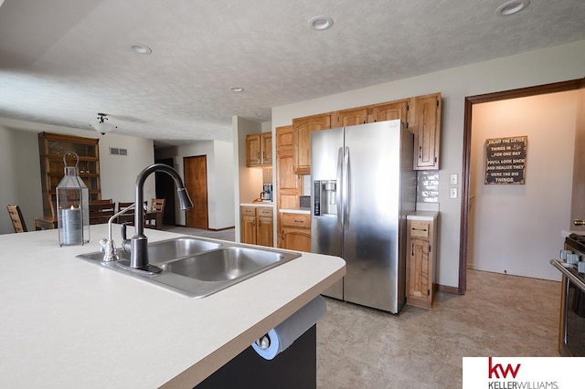 kitchen featuring a sink, light countertops, recessed lighting, and stainless steel appliances