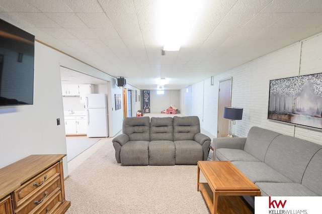 carpeted living area with a sink