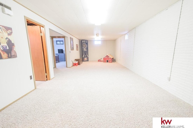 finished basement featuring visible vents and carpet flooring