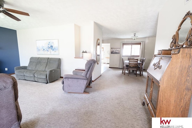 carpeted living room with a ceiling fan