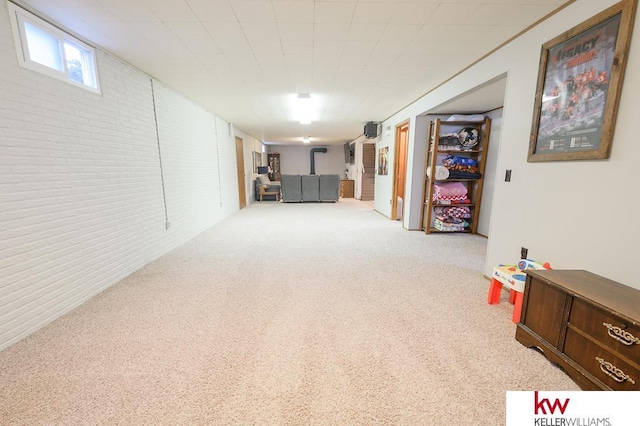 below grade area with brick wall and carpet floors