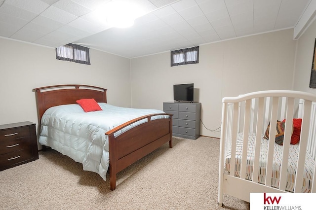 carpeted bedroom with ornamental molding