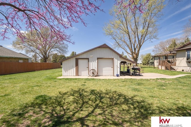 exterior space featuring fence and a garage