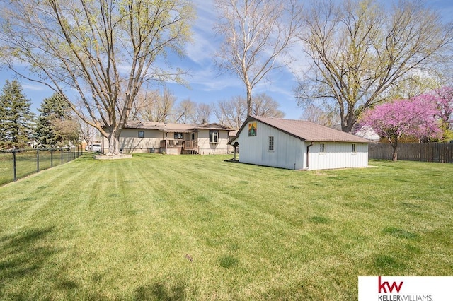 view of yard with a fenced backyard and an outdoor structure