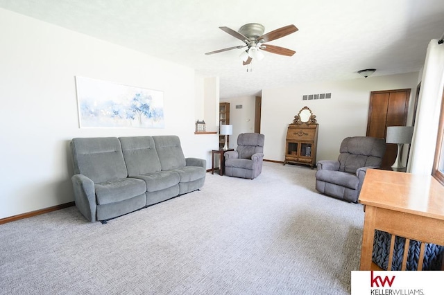 living area featuring ceiling fan, baseboards, carpet, and visible vents