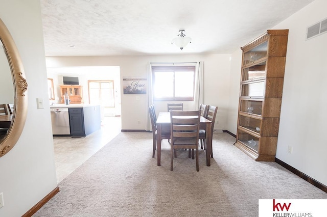 dining space with light carpet, baseboards, and visible vents