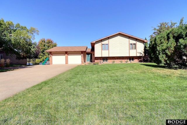tri-level home with a front lawn, driveway, a garage, and brick siding