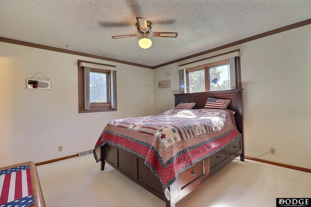 bedroom with a textured ceiling, multiple windows, and light carpet