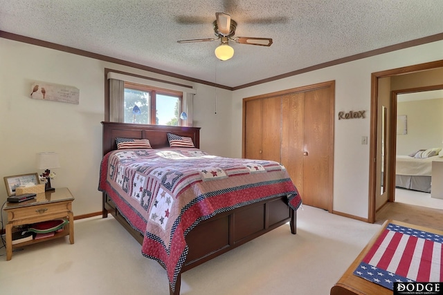 bedroom with a closet, a textured ceiling, ornamental molding, a ceiling fan, and light colored carpet