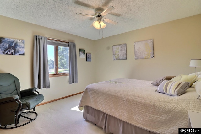 carpeted bedroom with a ceiling fan, baseboards, and a textured ceiling