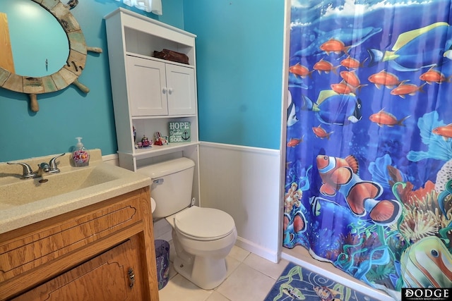 bathroom with a shower with curtain, tile patterned flooring, vanity, and toilet