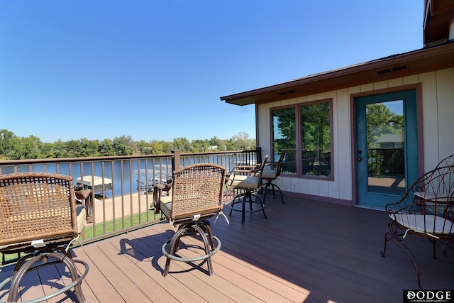 wooden terrace with a water view