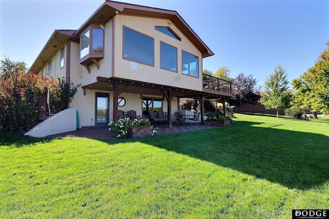 back of house with a wooden deck, a yard, and a patio area